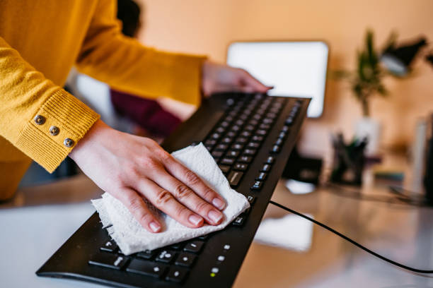 istock Woman cleaning keyboard 1322539974