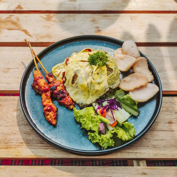 Photo of Nasi goreng fried rice with omelette and chicken satay