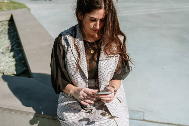 istock Young woman using a smartphone 1322543920