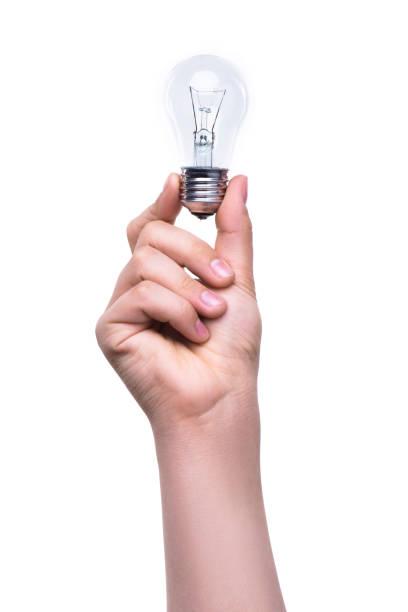 One man's hand holds a light bulb with fingers isolated on white background. Energy saving concept stock photo