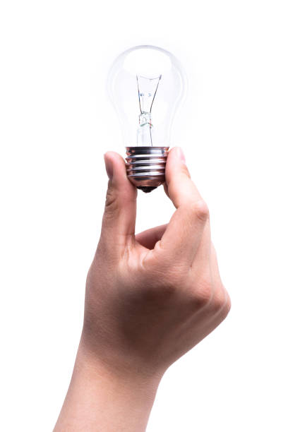 istock One man's hand holds a light bulb with fingers isolated on white background. Energy saving concept 1322545082