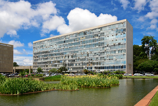 Brasília, Federal District, Brazil: headquarters of the Health Ministry (Ministério da Saúde do Brasil), the building is known as Bloco G, one of 17 similar blocks in the Ministries Esplanade - Monumental Axis - Esplanada dos Ministério. There were health guidelines since colonial times but a ministry responsible for health was only formed only in 1930 under president Getúlio Vargas.View from the pond of the Ministry of External Relations (Itamaraty Palace).