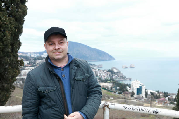 istock Man on background of bear mountain in evening 1322547714