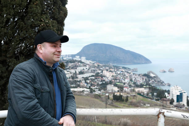 istock Man posing on background of bear mountain in evening 1322547716