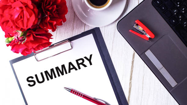 istock Summary written on a white background near red roses, a notebook and pen 1322547810