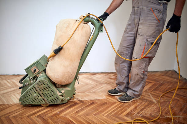 istock Repairman restoring parquet with a sanding machine. 1322548405
