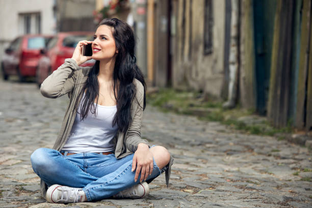 istock Young cute female using smartphone on the street. 1322549696