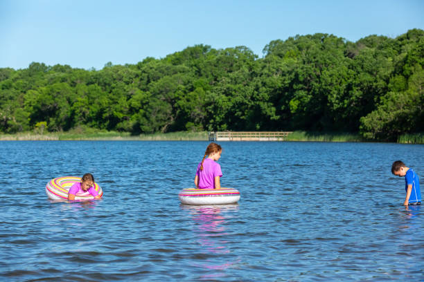 istock Three Children Playing In Water at Lake 1322549775