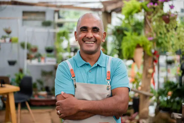 Photo of Small businessman smiling looking at camera.