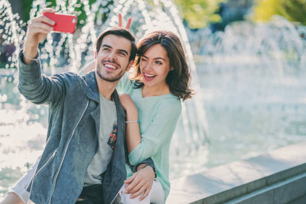 istock Couple in love taking selfie outside 1322551100