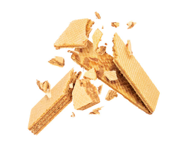 istock Crispy vanilla waffle is breaking into many pieces in the air on white background 1322555439