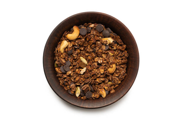 istock Chocolate granola cereal with nuts in a bowl background. 1322556330