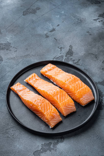 istock Fresh raw salmon fillet, on  grey background with space for text 1322556935