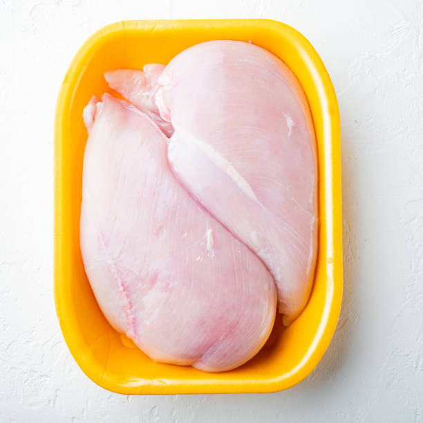 istock Fresh chicken breast meat in tray, on white background 1322556969