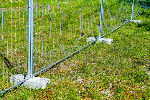 temporary galvanized steel fence parts that are installed in concrete weight racks hold the stability of the fencing