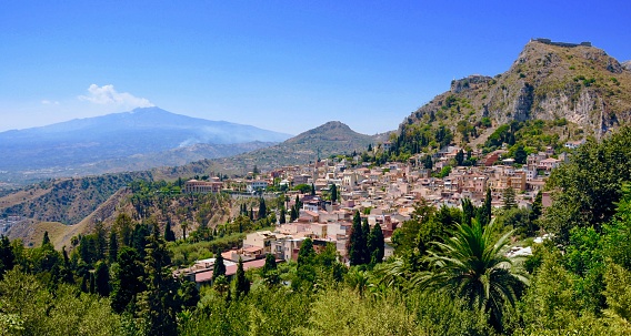 Taormina is a town on the east coast of Sicily. Cliffs drop to the sea toward sandy beaches.