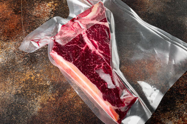 istock T bone or porterhouse dry aged  steak in vacuum pack , on old dark rustic background, with copy space for text 1322560927
