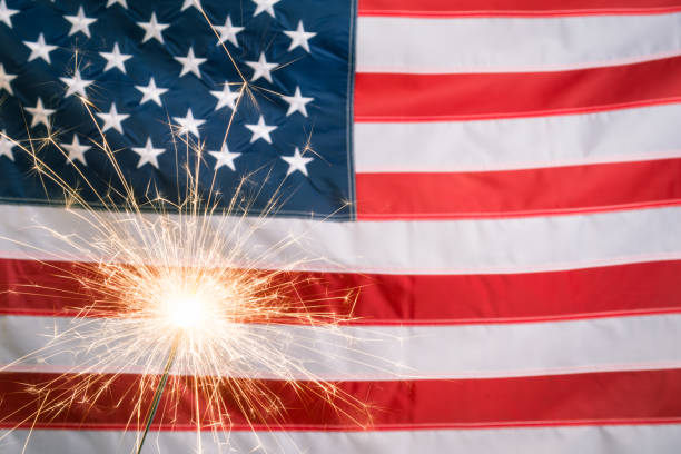 istock Glowing sparkler against US flag with copy space 1322561097