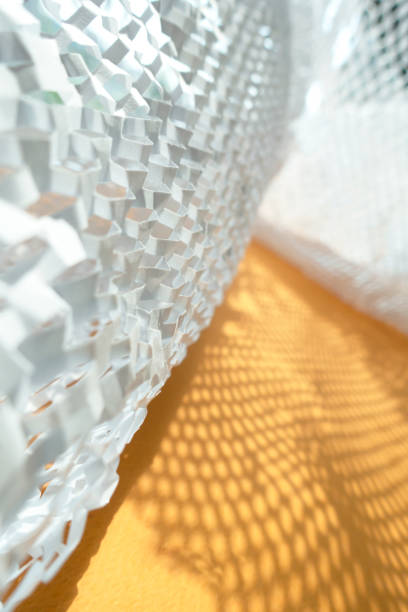 istock White cutted paper shadow under direct sunlight on yellow background. 1322562041