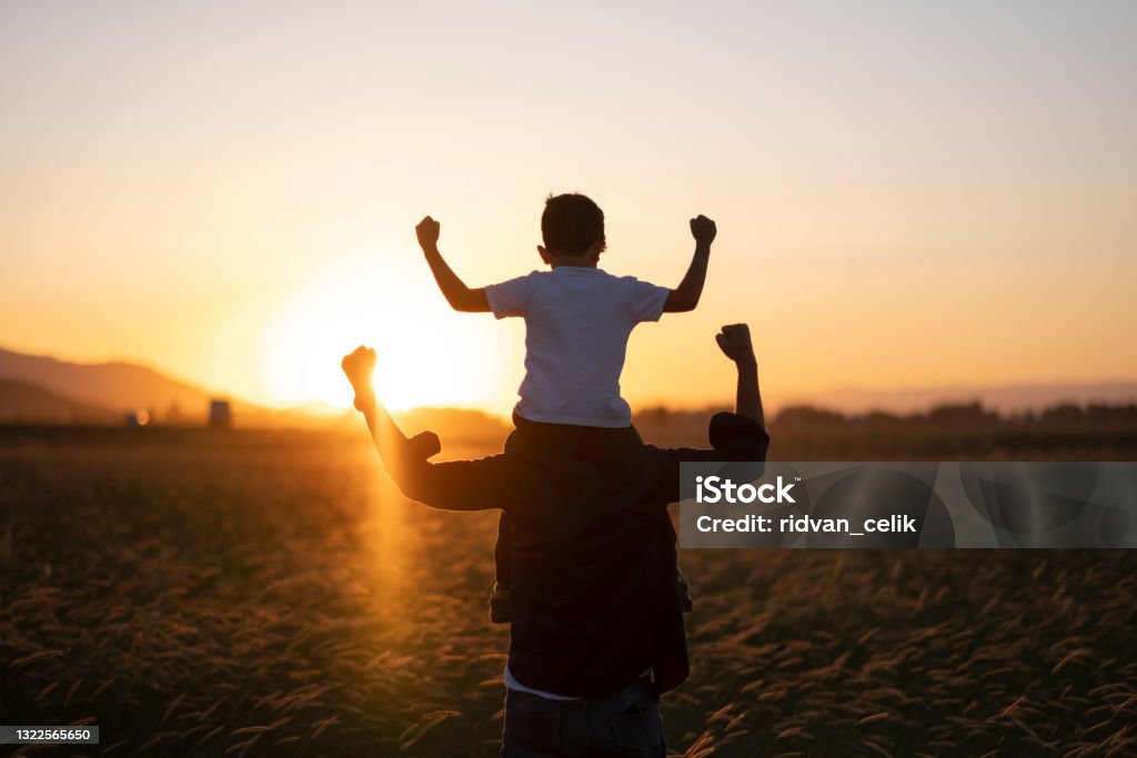 Dad and son outdoors Strength Stock Photo