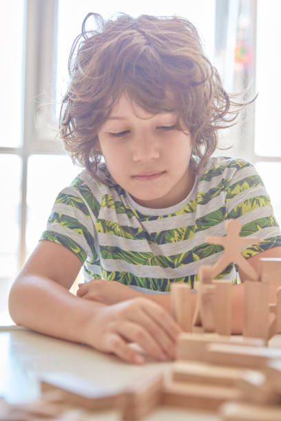 istock Cute little boy Playing with Wooden Blocks 1322565670