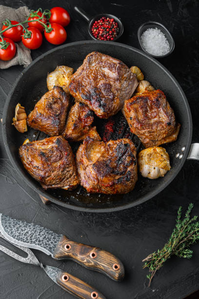 istock Delicious braised beef short ribs, on black stone background 1322566340