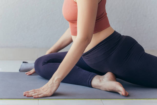 istock Unrecognizable Woman Practicing Yoga at Home 1322570535