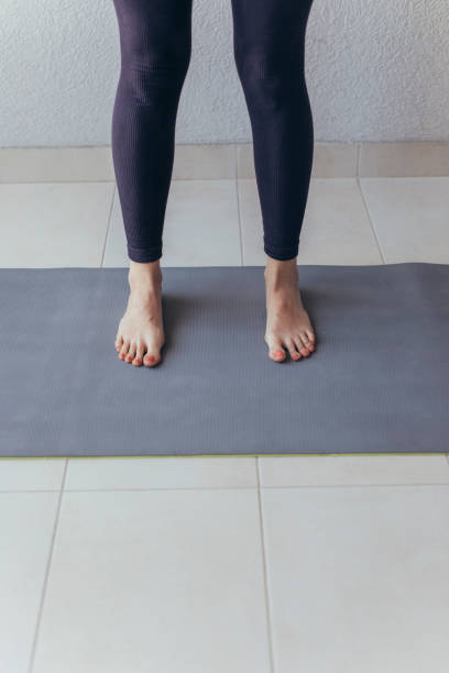 istock Unrecognizable Woman Standing on Exercise Mat 1322570544