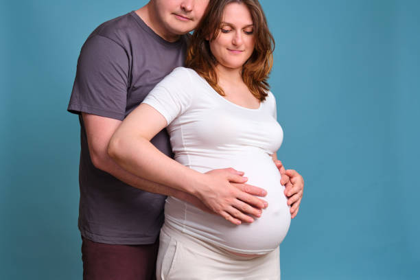 Mother and father touching belly