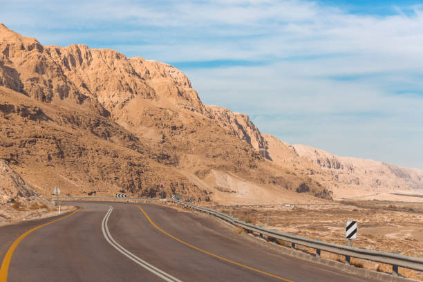 estrada ao longo do mar morto em israel - arid climate asphalt barren blue - fotografias e filmes do acervo