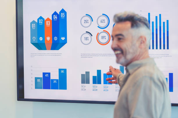 istock Mature businessman giving a presentation with graphs and charts. 1322578675
