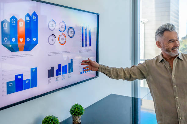 istock Mature businessman giving a presentation with graphs and charts. 1322578678