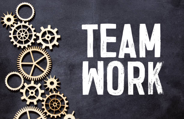 istock text TEAM WORK on black paper, business concept 1322579652