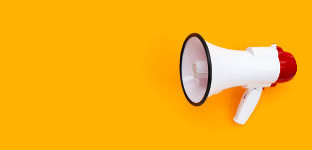 istock Red and white megaphone on orange background. 1322580568