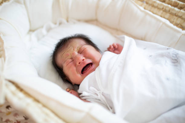 istock New born baby crying in a basinet close up 1322580629