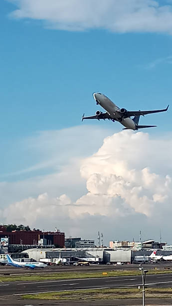 istock Airplane flying in the blue sky among the clouds 1322580717