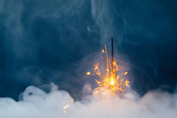 istock fire sparkler in dense smoke, abstract Christmas firework background 1322581539
