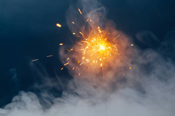 istock fire sparkler in dense smoke, abstract Christmas firework background 1322581550