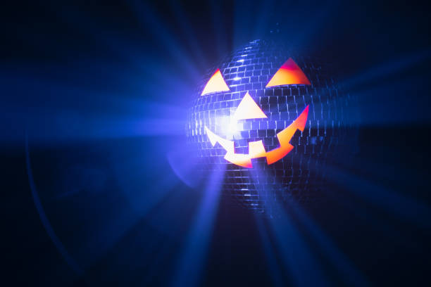 istock Halloween party pumpkin disco ball, jack o'lantern with shiny rays in smoke 1322581570