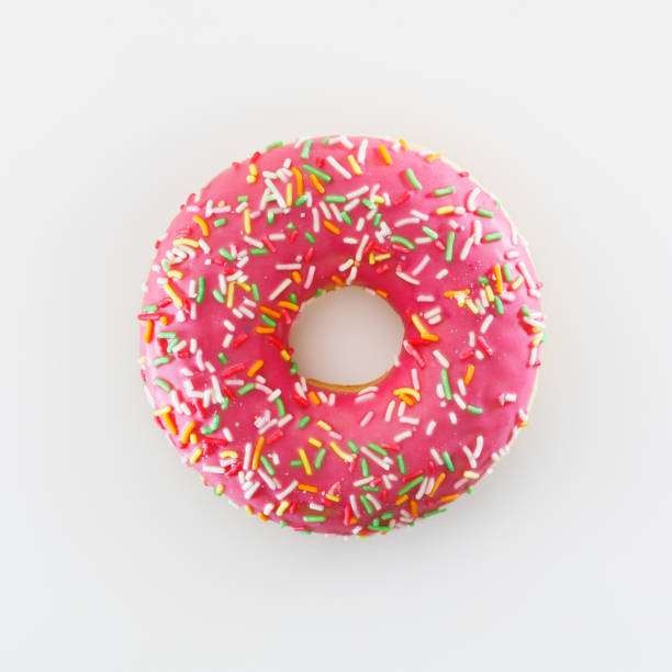 istock pink donut against white background 1322581708