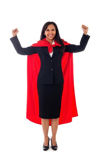 full length portrait of cheerful asian businesswoman dressed as superhero showing her fists, celebrates her success, isolated on white background