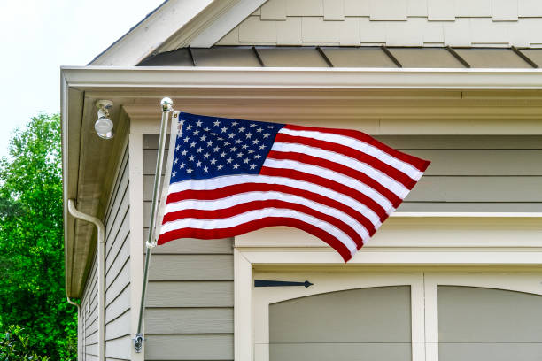 istock American Flag on Siding House 1322584261