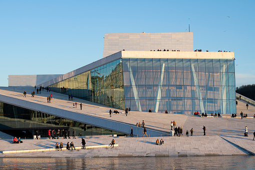 Oslo, Norway - February 23, 2020. Tourists walking or resting outside Oslo Opera House, Oslo, Norway