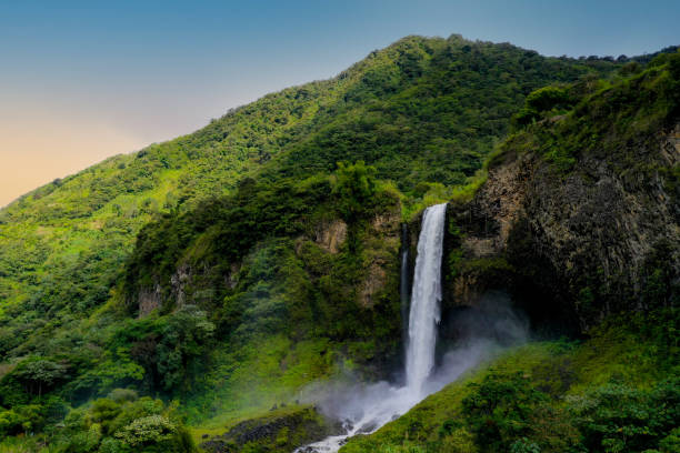 Background of a sideview of a beautifull waterfall in a mountain covered by trees during sunset Background of a sideview of a beautifull waterfall during sunset ecuador photos stock pictures, royalty-free photos & images