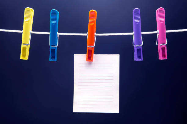 istock paper notepad for reminder hanging on colored clothespins 1322593280