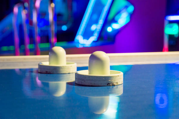 istock Air Hockey Paddles on a Table in an Arcade 1322598309