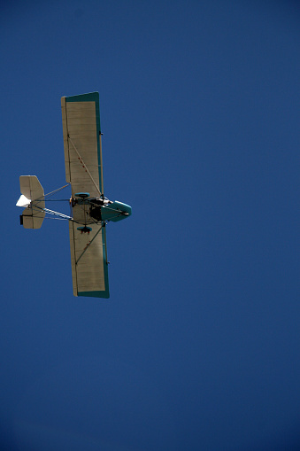 porto seguro, bahia / brazil - february 6, 2008: experimental ultralight plane is seen during flight in the sky in the city of Porto Seguro, in the south of Bahia.