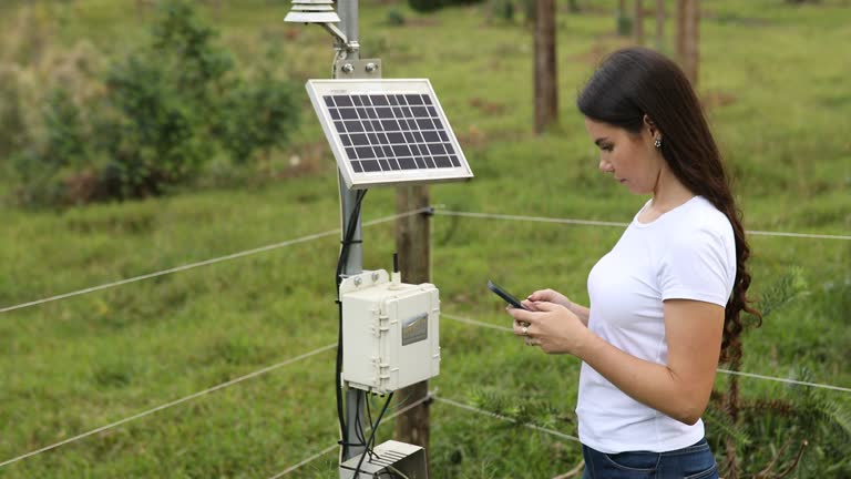 Woman checking and making adjustments to a meteorological station