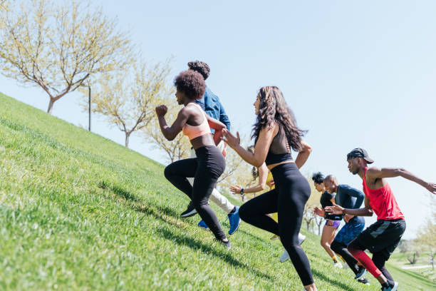 istock Group of runners running up a hill. 1322602117
