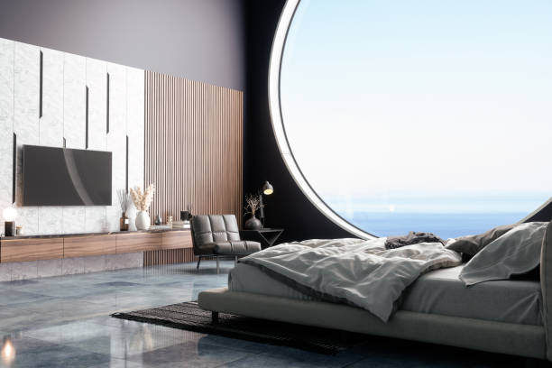 lussuoso interno della camera da letto con mobili da letto, poltrona e televisore in villa vacanze o in hotel. vista mare dalla finestra. - seaview foto e immagini stock